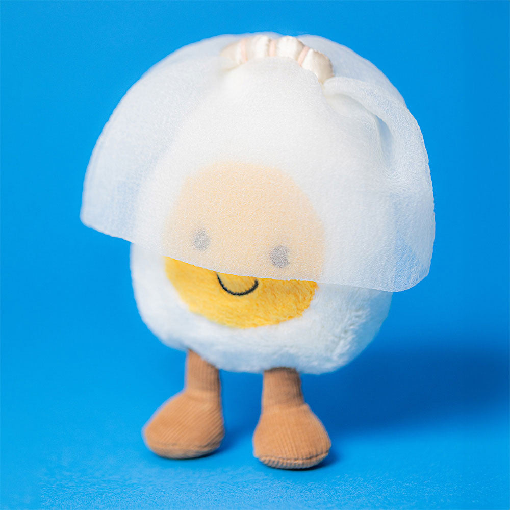 The Jellycat Amuseables Boiled Egg Bride is a plush toy with a smiling face, brown legs, and a white mesh veil—great for Jellycat enthusiasts and collectors of cute, unique plushies.