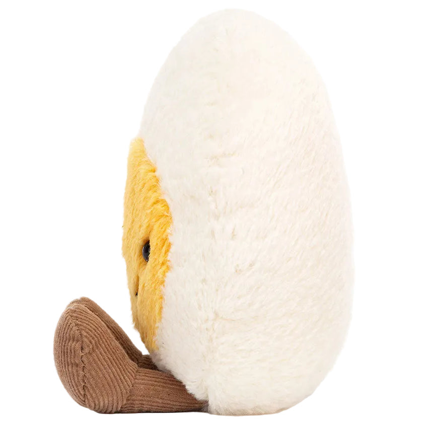 Plush toy shaped like a half-peeled banana with a yellow face, white outer layer, and brown bottom, shown from the side—this cheerful Jellycat creation is as playful as the Amuseables Boiled Egg Happy by Jellycat.