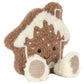 Jellycat Amuseables Molasi Cookie plush in the shape of a gingerbread house with a smiling face, white icing trim, and two soft feet.