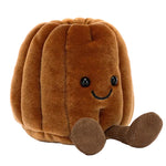 A plush toy shaped like a brown pumpkin with button eyes, a stitched smile, and two soft legs—this pastry plush is as sweet and huggable as Jellycat's Amuseables Carole Canele.