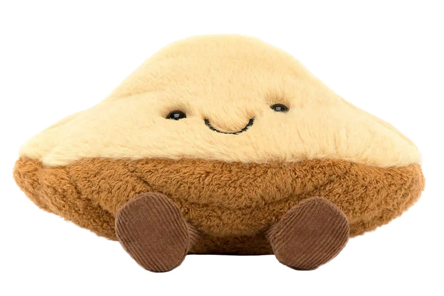 The Jellycat Amuseables Margaux Madeleine plush toy features a smiling face and small brown feet in a cute madeleine shape, displayed against a white background.
