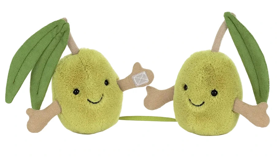 The Jellycat Amuseables Pair of Olives features two plush olives with green leaves, brown stems, small arms, and smiling faces joined by a short green string—perfect for you and your favorite magician’s assistants.