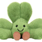 Amuseables Siofra Shamrock by Jellycat is a plush green four-leaf clover toy with a smiling face and two brown feet, perfect for adding luck and charm to any collection.