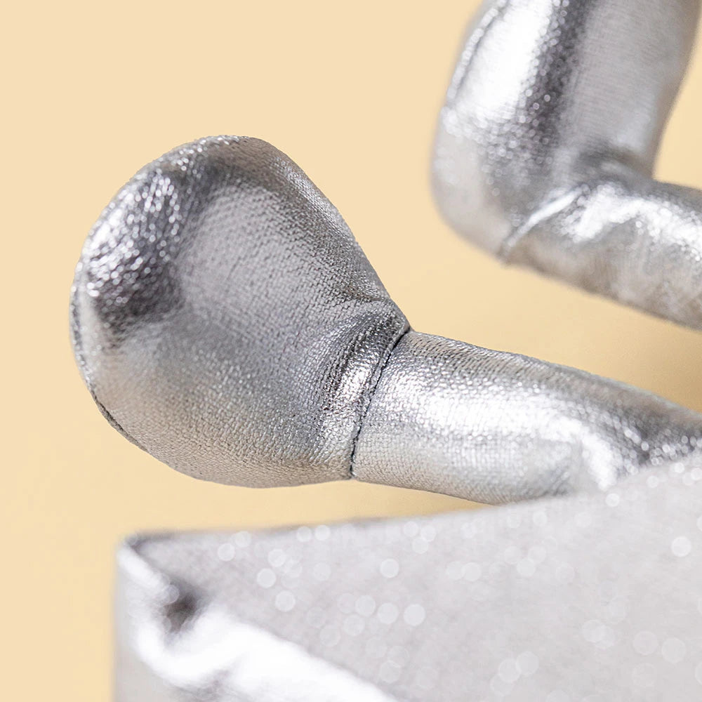 Close-up of two silver fabric fingers on the Amuseables Silver Star by Jellycat, set against a beige background—perfect as a winter gift.
