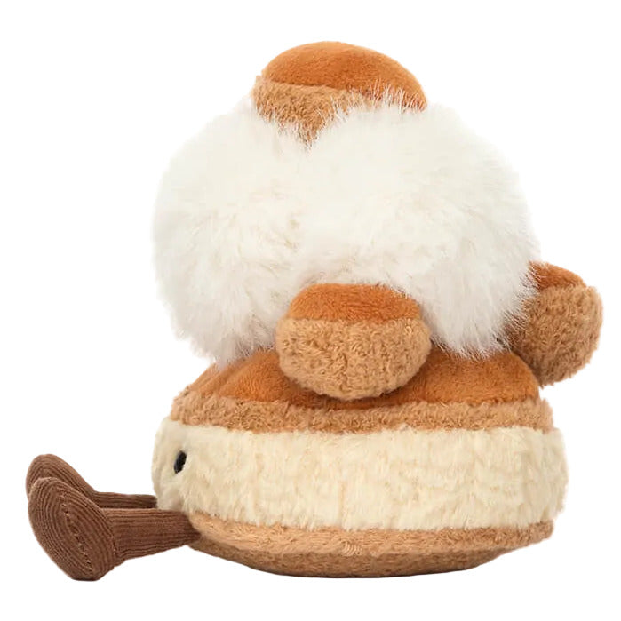 The Jellycat Amuseables Mirielle St. Honoré Cake plush features a round tan-and-cream design, fluffy white top, and small brown pipe—perfect for adding charm to any spin studio or cozy corner.