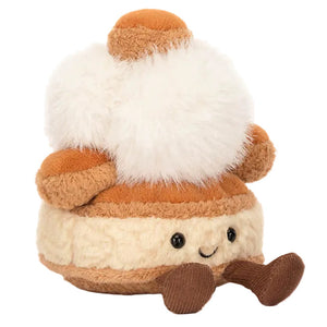 The Jellycat Amuseables Mirielle St. Honoré Cake is a plush toy shaped like a cream-filled pastry, with a smiling face, brown legs, and fluffy white topping; part of the adorable Patisserie collection.