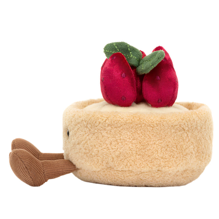 The Amuseables Fleurette Tarte Aux Fraises by Jellycat is a plush pie toy featuring red strawberries and green leaves on a soft tan crust, complete with a brown handle.