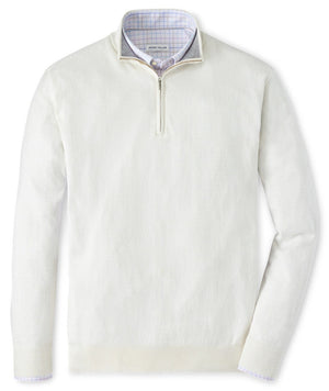 A Peter Millar Whitaker Quarter-Zip Sweater in a cream-colored cotton-Tencel blend, layered over a light checkered dress shirt with a standing collar.