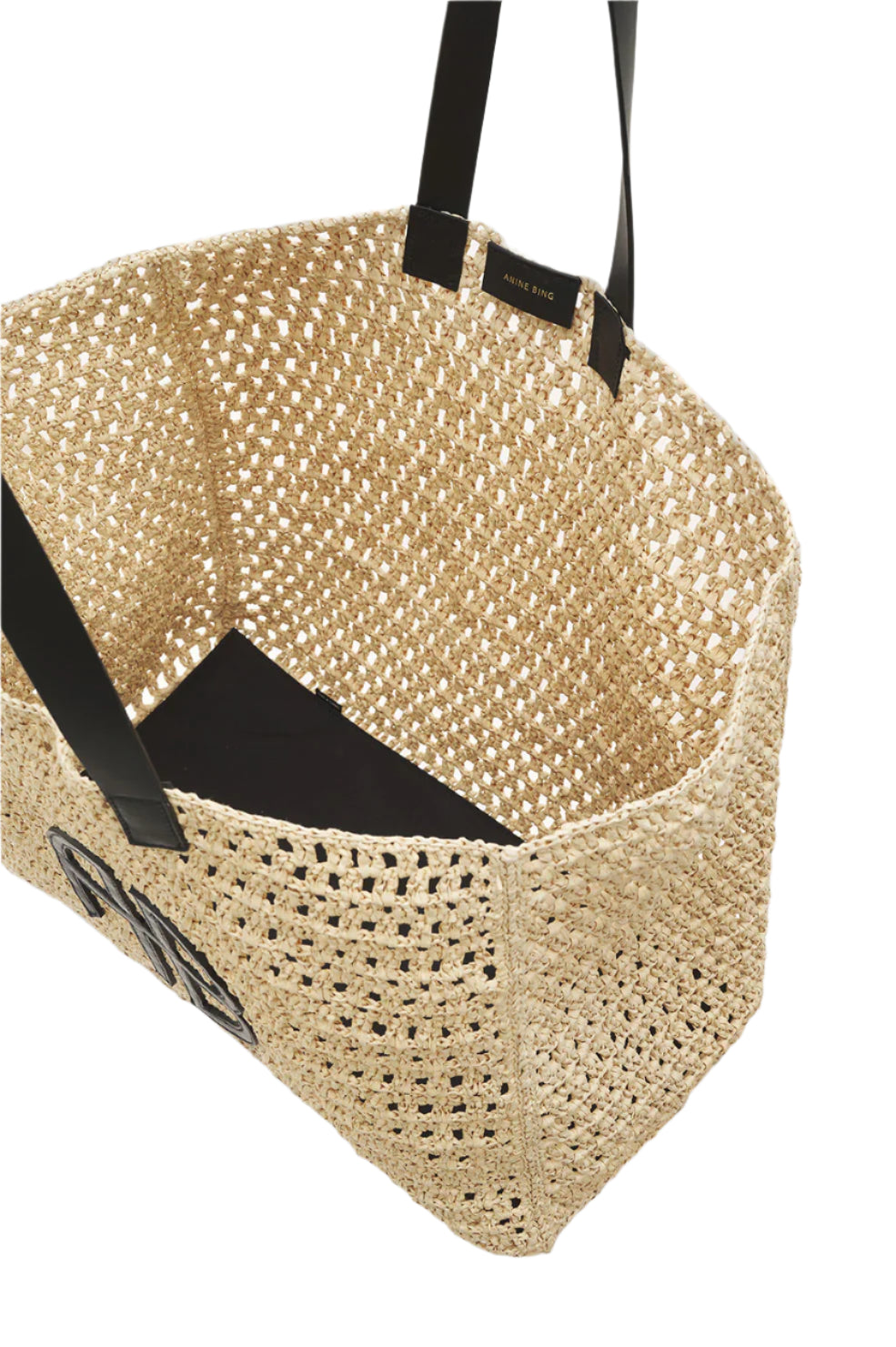 The Anine Bing Large Rio Tote is a woven seagrass bag featuring black handles and a black rectangular inner base, shown from above at an angle.