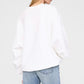 A person is shown from the back against a plain background wearing the Anine Bing Miles Sweatshirt Framed Monogram and light blue jeans.