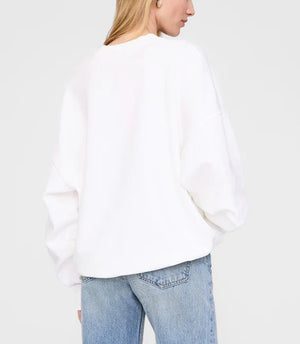 A person is shown from the back against a plain background wearing the Anine Bing Miles Sweatshirt Framed Monogram and light blue jeans.