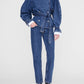 Wearing the Anine Bing Pascale Trench, styled as transitional outerwear, paired with matching denim pants and black heeled boots, this person stands against a plain white background.