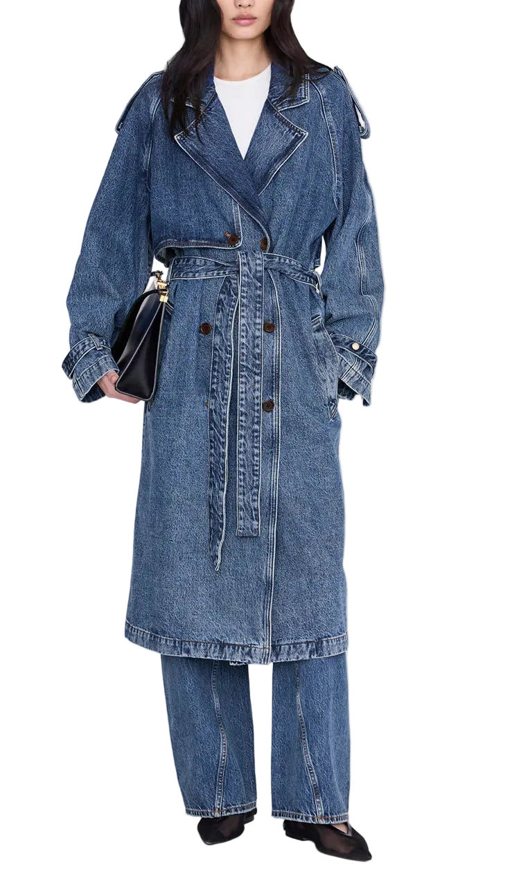 Wearing the Rickie Maxi Denim Trench by Anine Bing with coordinating wide-leg jeans, this person channels a menswear-inspired style, accessorized with a black handbag and black shoes.