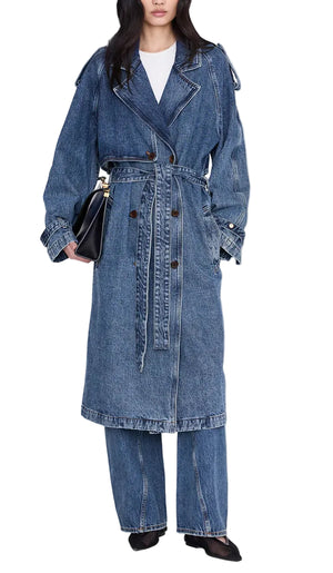 Wearing the Rickie Maxi Denim Trench by Anine Bing with coordinating wide-leg jeans, this person channels a menswear-inspired style, accessorized with a black handbag and black shoes.