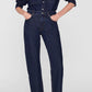 Wearing the Anine Bing Samy Shirt—a dark cotton denim canvas button-up—tucked into matching high-waisted jeans, with hands in pockets and paired with maroon slingback heels.