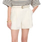 A person wears a black-and-white striped top with Anine Bing's high-waisted Trent Short, crafted from suiting fabric and finished with a matching belt, posing with one hand in the pocket.