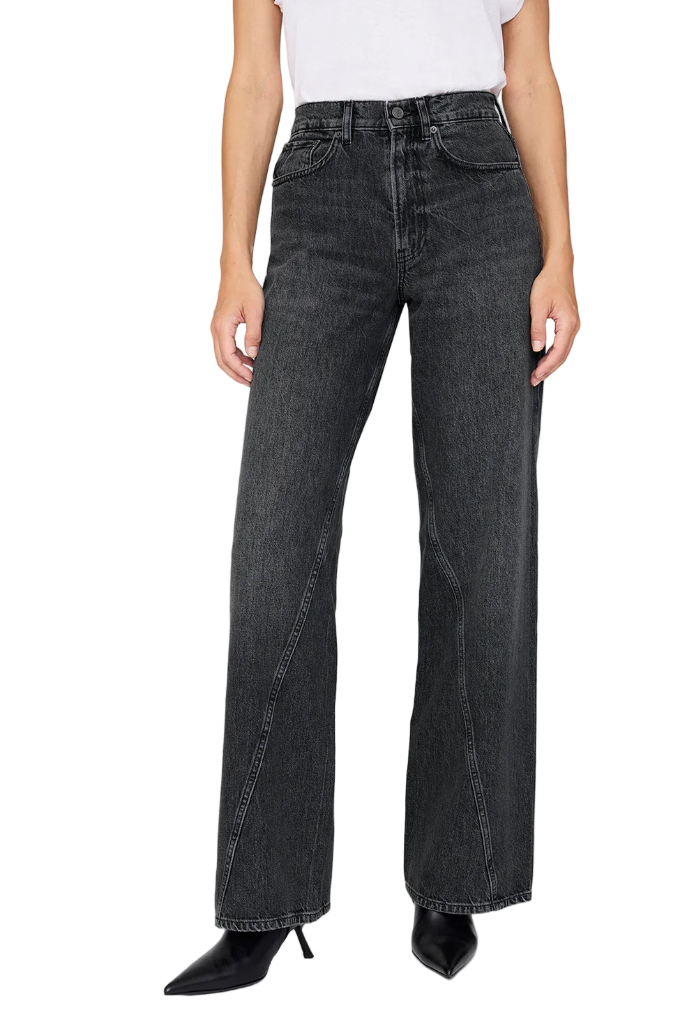 Wearing the Anine Bing Brie Jean—high-waisted, dark wash, wide-leg jeans in rigid cotton denim—paired with a white tee and black pointed-toe boots, standing against a plain background.