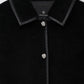 Close-up of the Anine Bing Camden Jacket, featuring a black textured wool blend fabric, a black leather-trimmed collar, and silver buttons, with an “Anine Bing” label displayed inside the collar.