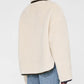 A person is shown from the back wearing the cream Camden Jacket by Anine Bing with light blue jeans against a plain white background.