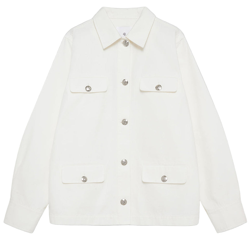The Corey Jacket by Anine Bing is a white cotton canvas jacket featuring long sleeves, a collar, and four front flap pockets with button closures.