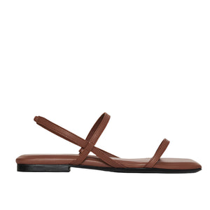 The Anine Bing Hilda Flat Sandals feature brown leather with two slender instep straps, a cushioned footbed for comfort, and a low heel.