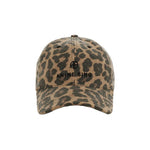 A front view of the Anine Bing Jeremy Leopard Baseball Cap, showcasing its tan and brown leopard print design with black embroidered text and logo on the front panel, featuring an adjustable back strap for a perfect fit, displayed on a white background.