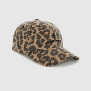 The Jeremy Leopard Baseball Cap by Anine Bing features a leopard print design with a curved brim and the brand's logo embroidered on the front. It includes an adjustable back strap for a personalized fit and is shown against a plain white background.