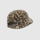 The Jeremy Leopard Baseball Cap by Anine Bing is a leopard print baseball cap with an adjustable back strap and a metal buckle, featuring the text "ANINE BING" on the back.