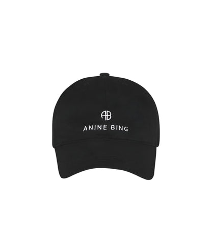 The Jeremy Baseball Cap by Anine Bing in black features a white embroidered logo and "AB ANINE BING" text on the front, plus an adjustable back strap, shown against a plain white background.