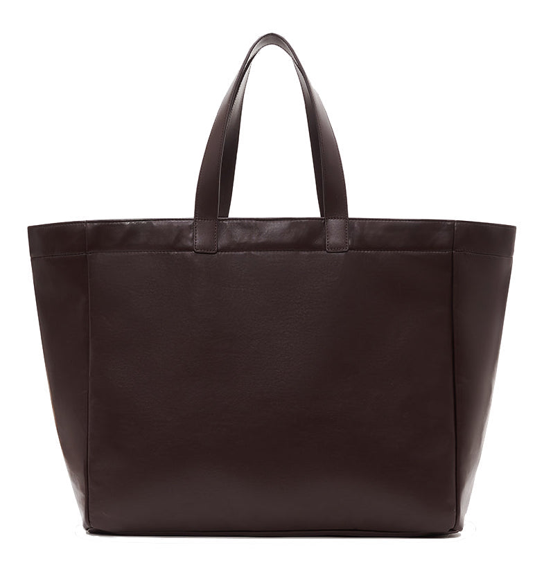 The Large Rio Tote by Anine Bing is a dark brown leather bag with two short handles, shown against a white background—a stylish everyday essential.