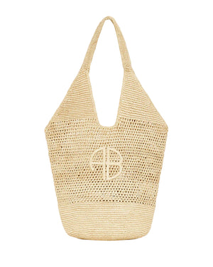 The Leah Logo Hobo by Anine Bing is a beige natural raffia straw tote with a wide handle and circular embroidered logo, inspired by classic Anine Bing style.