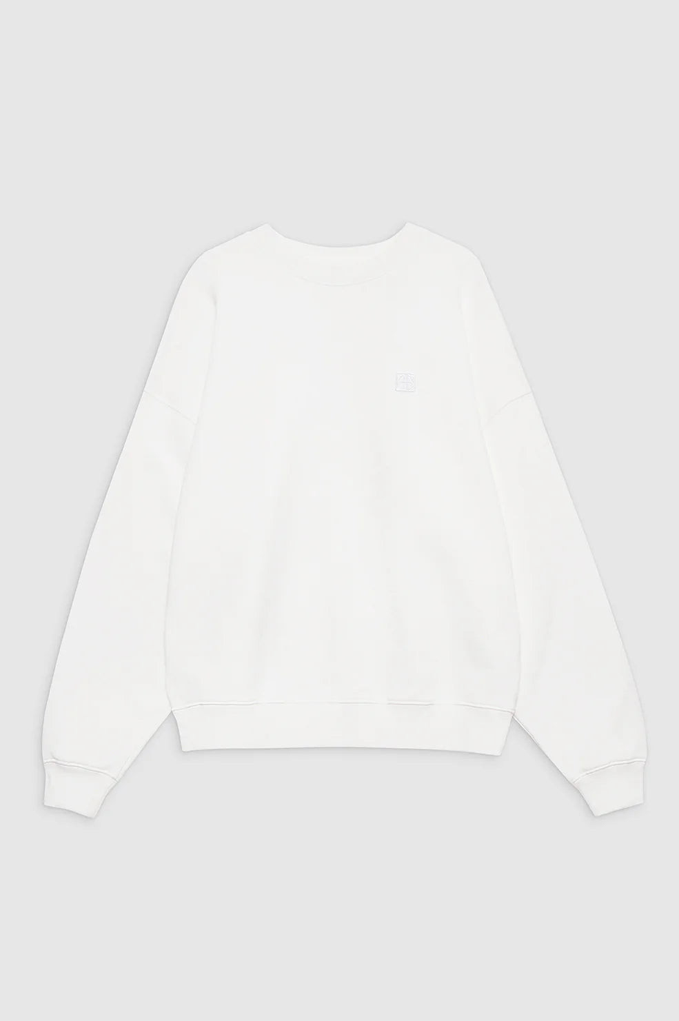 The Anine Bing Miles Sweatshirt Framed Monogram is a plain white cotton fleece crewneck with long sleeves, shown laid flat on a light grey background.