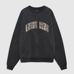 Introducing the Miles Anine Bing Leopard Sweatshirt by Anine Bing—a black oversized sweatshirt made from organic cotton fleece, showcasing "ANINE BING" in bold, leopard-print block letters across the chest.