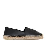 The Paloma Espadrilles from Anine Bing feature a sleek black leather finish with a woven jute sole and an embossed front monogram, combining elegance with comfort in a classic slip-on design.