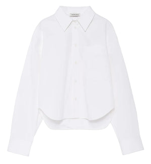 The Scott Cropped Shirt by Anine Bing is a white long-sleeve button-up featuring a collar, chest pocket, and subtly curved hem. Made from crisp cotton poplin for comfortable wear, it boasts a relaxed silhouette and is showcased against a plain white background.