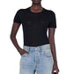 Model wearing the Anine Bing Sylvie Tee, a fitted black super soft crewneck top, paired with light blue high-waisted jeans, standing against a white background.