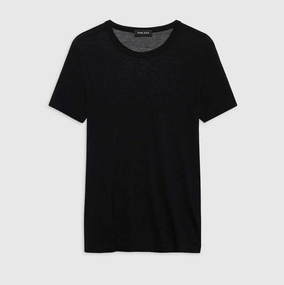 The Sylvie Tee by Anine Bing, a super soft plain black short-sleeve crewneck, is displayed against a light gray background.