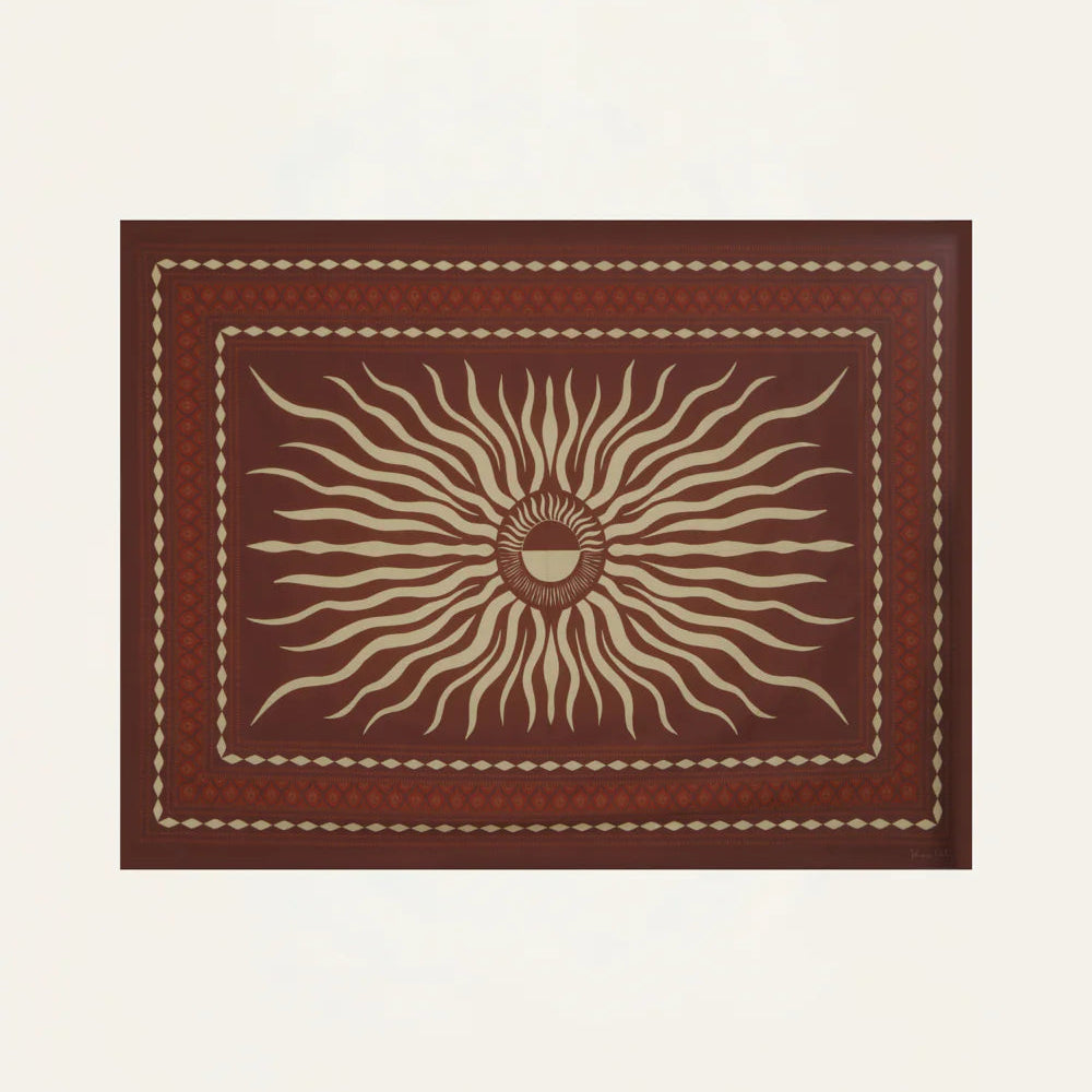 The Golden Horizon Pareo by Johanna Ortiz features a central sunburst motif in beige on deep red, framed by geometric beige and red borders—ideal for personal styling or as a versatile scarf-inspired accent.