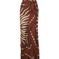 The Golden Horizon Pareo by Johanna Ortiz features a brown and cream wavy stripe pattern, adjustable waist tie, and chic wrap style—perfect for styling or wearing as a versatile pareo.