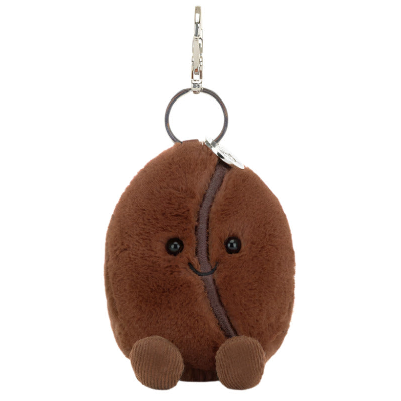 The Jellycat Amuseables Coffee Bean Bag Charm is a plush, smiling brown bean keychain with small feet and a metal clip—an adorable accessory for your bag.