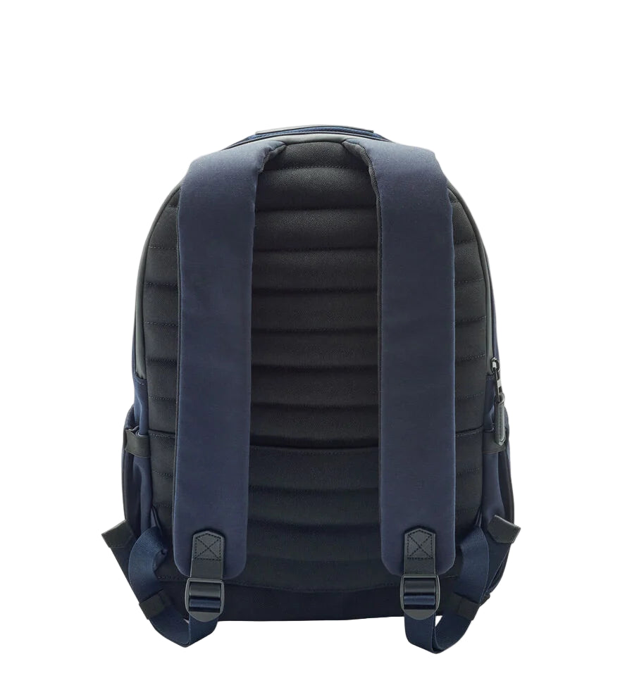 The Peter Millar Pursuit Backpack in navy and black is shown from the back, highlighting padded shoulder straps, a quilted cushioned back panel, and a dedicated laptop pocket.