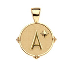 The Jane Win Letter Pendant Satellite Necklace Collection features a 14k gold pendant with a raised "A" and star on a textured round background, paired with a beaded satellite chain for personalized style.