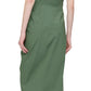 A person is seen from behind wearing Callas Milano's Agnes Dress, a sleeveless green wrap midi crafted from luxurious Italian cotton, paired with black shoes.