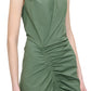 A person wearing the Agnes Dress, a sleeveless V-neck wrap dress by Callas Milano, featuring a ruched design and crafted from premium green Italian cotton.