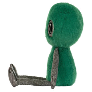 The Jellycat Zyllan Alien plush toy features a round galactic green fuzzy body, big black eye, and shiny silver arms and legs, sitting upright and facing sideways.