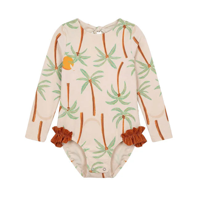 The Pepita & Me Baby Girls' and Girls' Alana Longsleeve Rashguard features a beige design with green palm tree print, brown hip ruffles, UPF50+ protection, and easy snap closures at the crotch.