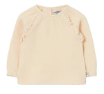 The Cozmo Baby Girls’ Anisa Blouse features long sleeves in a light beige hue, with delicate ruffle details on the shoulders and a round neckline. Made from textured cotton, the fabric is soft with a gentle crinkled finish.