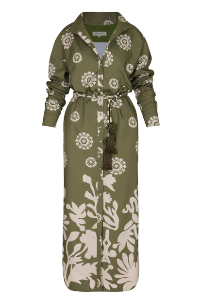 A full-length Andres Otalora Armenia Dress in green and white print with long sleeves, featuring a button-up front, a belted waist, and made from 100% cotton.