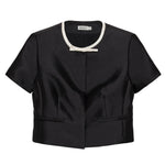 Simkhai Naelle Top in structured black satin, featuring a cropped short-sleeve silhouette, white crew neckline, and a small decorative bow at the center.