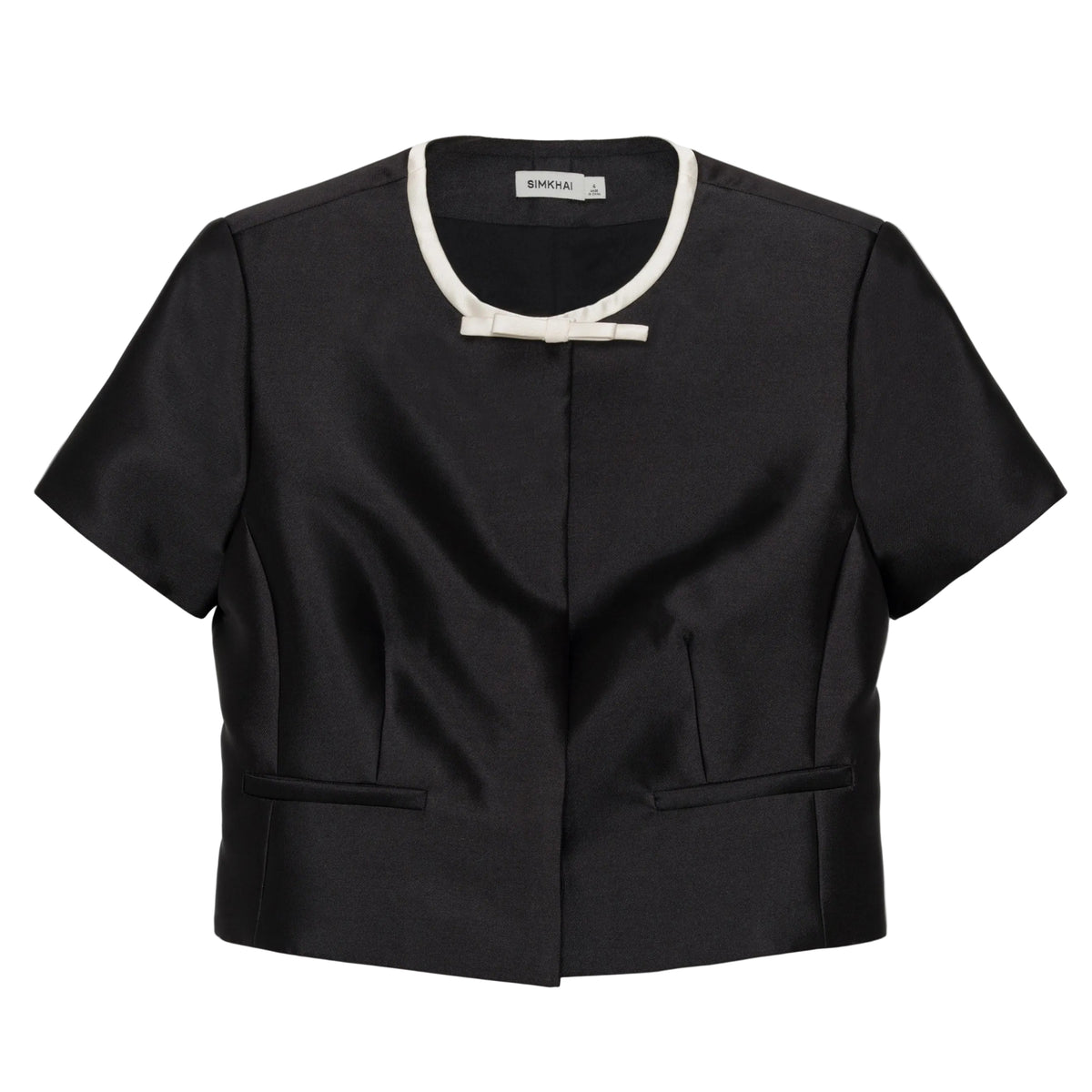Simkhai Naelle Top in structured black satin, featuring a cropped short-sleeve silhouette, white crew neckline, and a small decorative bow at the center.